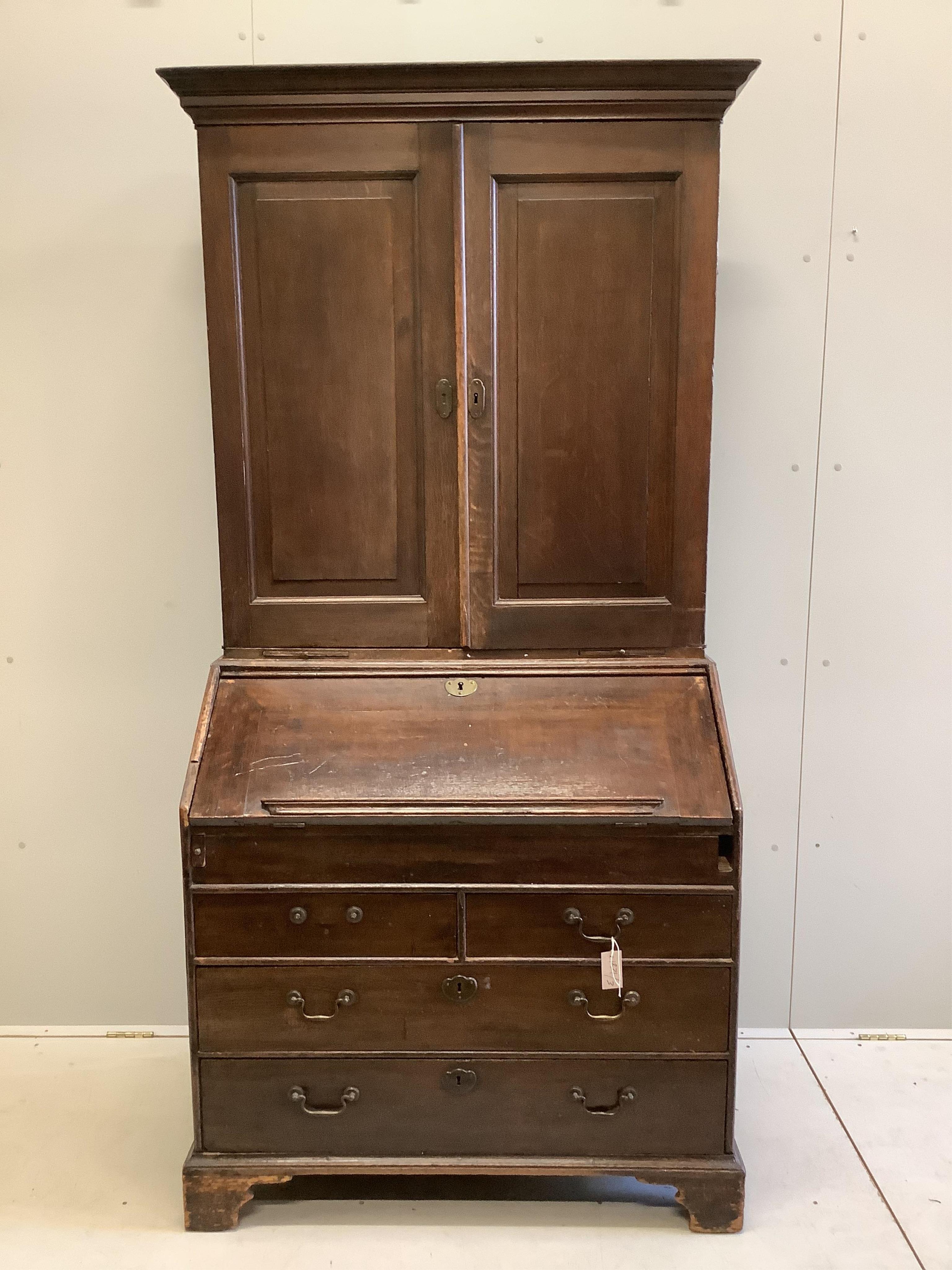 A George III oak bureau cabinet, width 96cm, depth 59cm, height 201cm